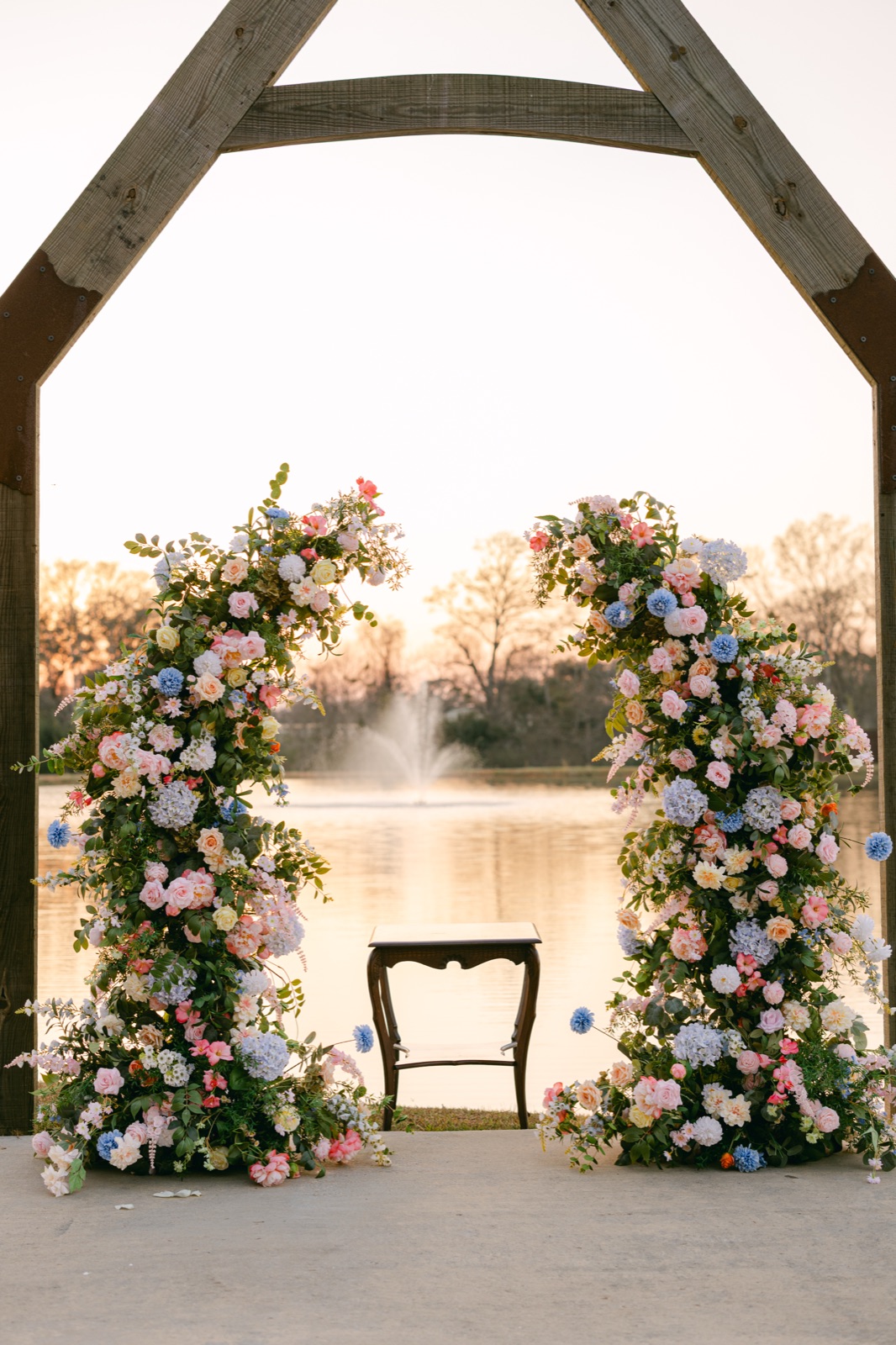 Ellie floral arches framing a lakeside ceremony